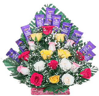 A vibrant flower arrangement with assorted roses and chocolates.