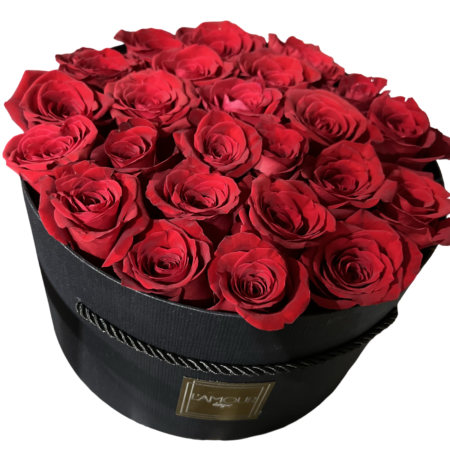 A luxurious and classic floral presentation featuring deep red roses meticulously arranged in a sleek round black hatbox from L’amour Designs. The tight dome of velvety roses is rich in color and romance, making it a bold and unforgettable gift—perfect for grand gestures of love and admiration.