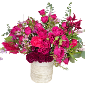 A dramatic and passionate floral arrangement set in a white textured ceramic vase, bursting with vibrant shades of deep pink, burgundy, and fuchsia. The bouquet includes hot pink spray roses, burgundy coxcomb, fuchsia carnations, pink waxflower, celosia, veronica, eucalyptus, and delicate filler blooms. Designed with height, texture, and intensity, this arrangement makes a bold romantic or celebratory statement.