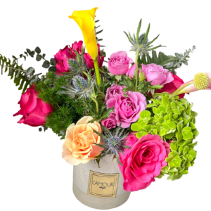 A vibrant floral arrangement with roses and green accents in a white vase.