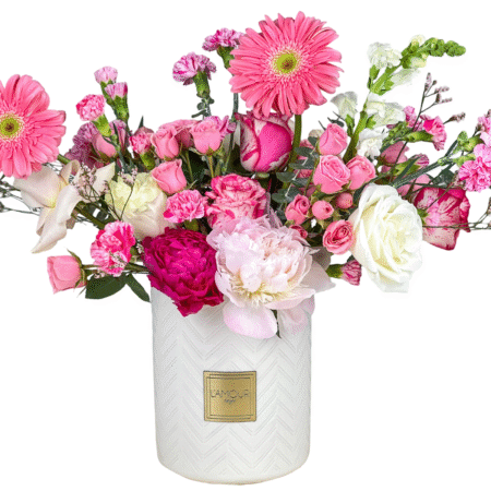 Pink and white flowers in decorative vase.